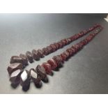 A GRADUATED CHERRY AMBER NECKLACE