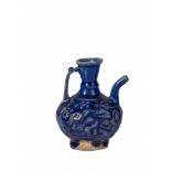 A COBALT BLUE MOULDED GLAZED KASHAN EWER WITH HANDLE, 12TH CENTURY PERSIA