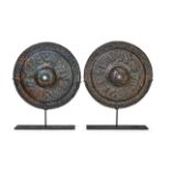 A HIGHLY RARE PAIR OF SELJUK ENGRAVED AND PIERCED BRONZE MIRRORS, KHORASSAN 12TH CENTURY