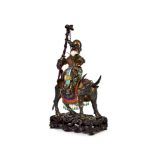A GILT BRONZE FIGURE OF A SEATED BUDDHA ON A DONKEY, MOUNTED ON A ROSE WOOD STAND, 19TH CENTURY