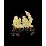 A CARVED RUSSET JADE GROUP OF AN ELDER MAN & AN ATTENDANT TRAVELLING ON A BOAT, QING DYNASTY