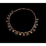 AN EGYPTIAN CARNELIAN AND AGATE BEAD AMULETIC NECKLACE, THIRD INTERMEDIATE PERIOD, 21ST-22ND DYNASTY