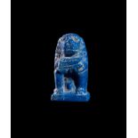 AN EGYPTIAN LAPIS LAZULI AMULET OF A BABOON, PTOLEMAIC PERIOD 332-30 B.C.
