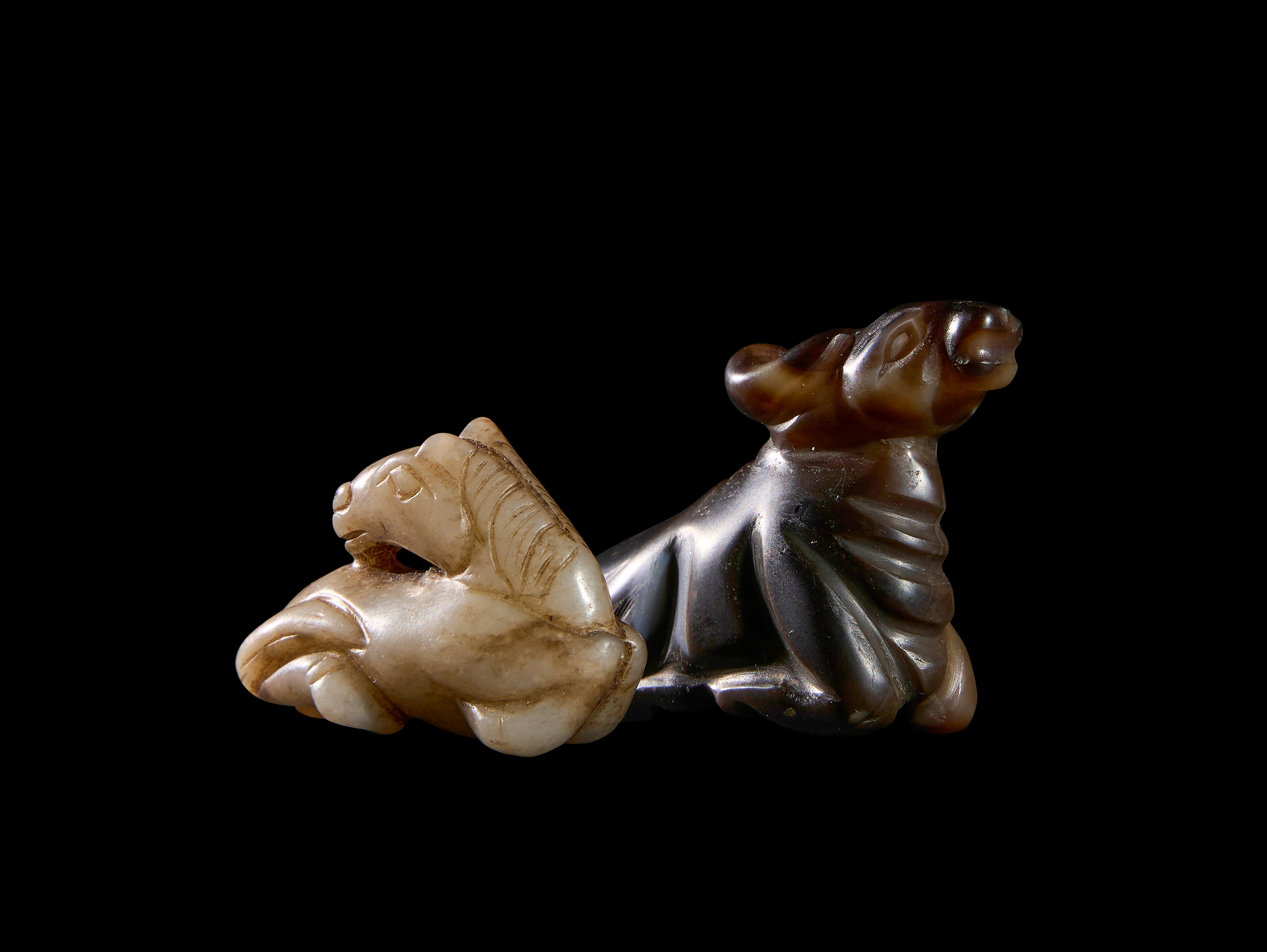 TWO AGATE SEATED HORSES