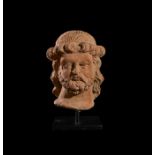 A GANDHARA TERRACOTTA BUST OF A NOBLE MAN, CIRCA 5TH CENTURY CE OR LATER