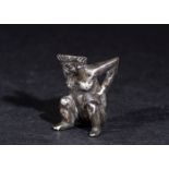 A RARE ROMAN GAME PIECE DICE FIGURE IN SILVER DEPICTING A SQUATTING FEMALE GODDESS, 1ST CENTURY A.D.