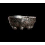 A SILVER HELLENISTIC RIBBED GEOMETRICAL BOWL WITH FACES CIRCA 3RD-2ND CENTURY B.C.