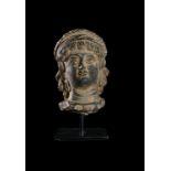 A GANDHARA GREY SCHIST BUST OF A NOBLE WOMAN, CIRCA 4TH-5TH CENTURY CE