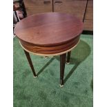 Circular acccent table with brass trim This stunning accent table is perfect for use as a side table