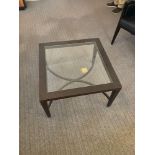 A glass top black framed coffee table with under stretcher 70 cm x 70 cm Room LG20 ( East Wing )