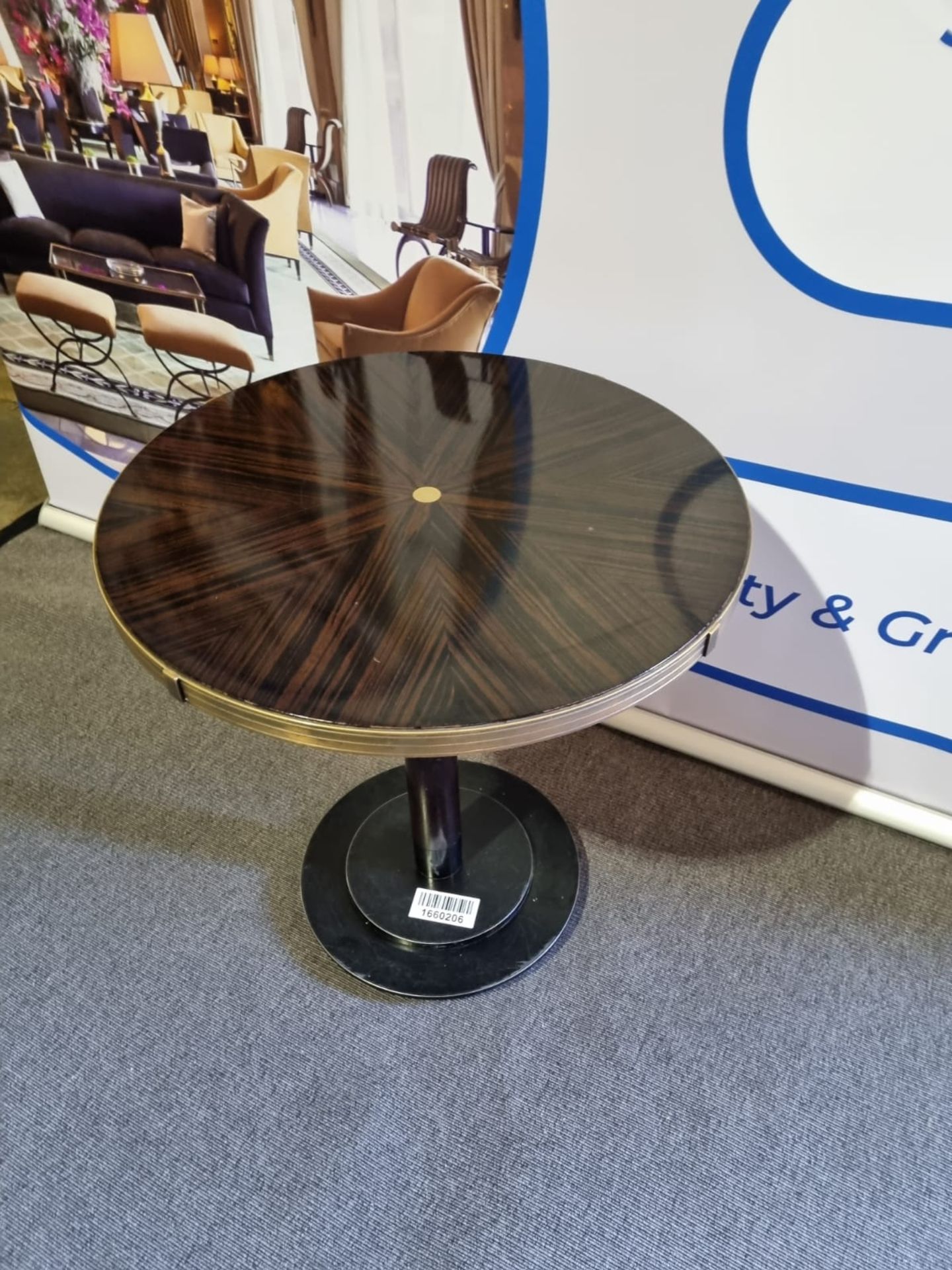 Macassar Ebony circular top dining table with brass trim mounted on a cast iron pedestal base 70 x