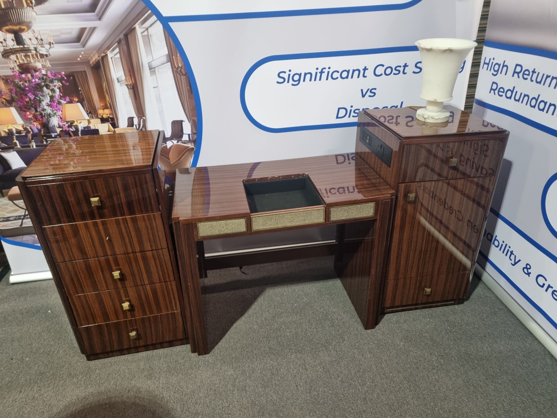 Burr mahogany reception counter with brass trim black marble shaped topand marble plinth skirt