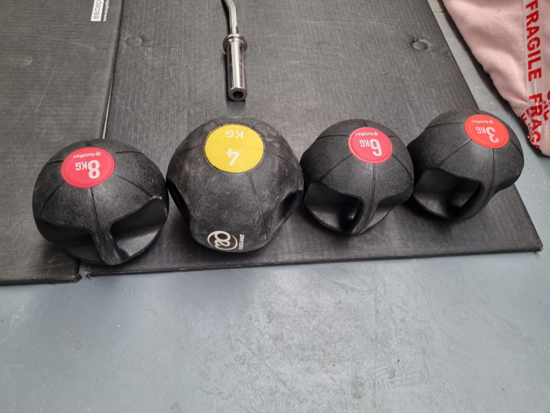 A set of Bodymax double handled medicine balls ranging from 3kg to 8kg set of 4