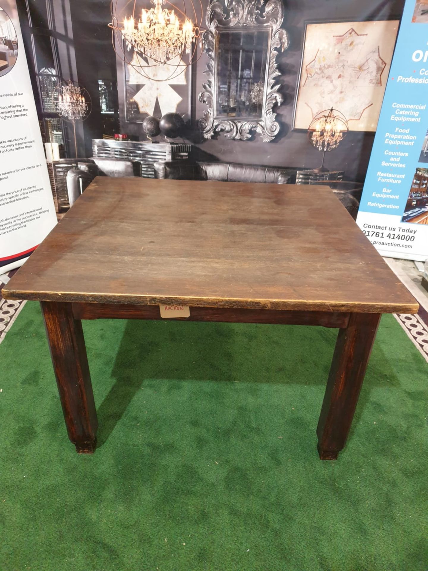 An English stained oak dining table. The square top on square chamfered legs with tapered feet. c.