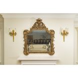 Carved Wood and Gilded Overmantel Mirror The frame has a carved moulded edge of scrolling acanthus