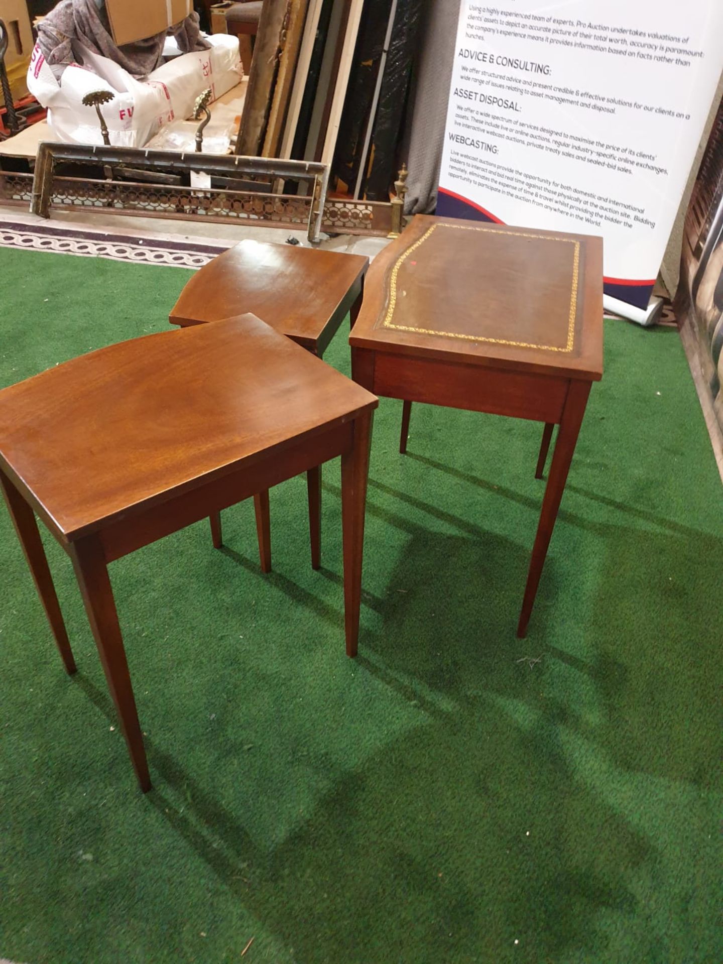 A nest of three mahogany bow front tables in the George III style. The largest table with a gilt - Image 4 of 5