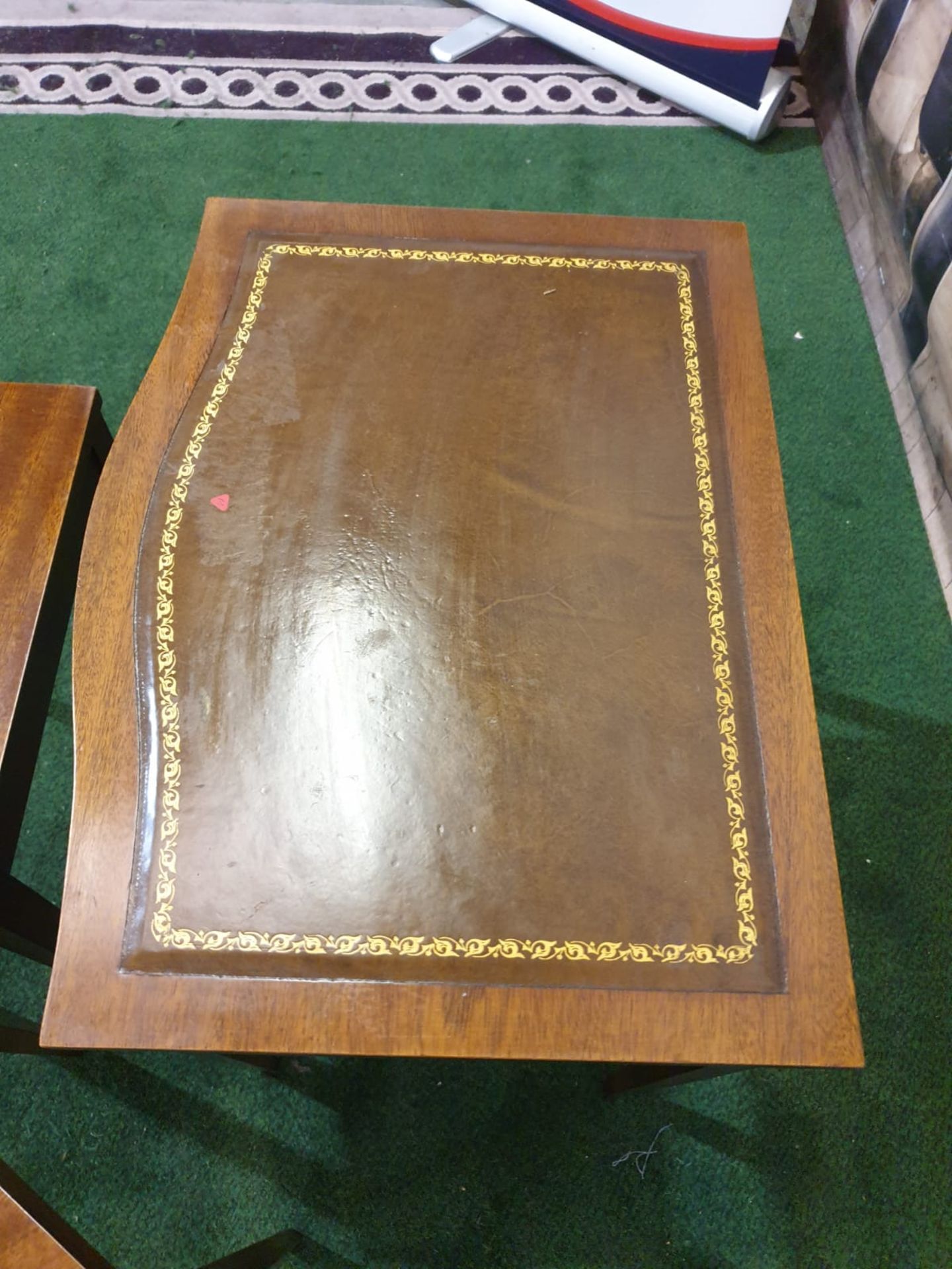 A nest of three mahogany bow front tables in the George III style. The largest table with a gilt - Image 5 of 5