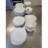 A large selection of white table wear comprising of dinner plates, side plates, bowls etc as found