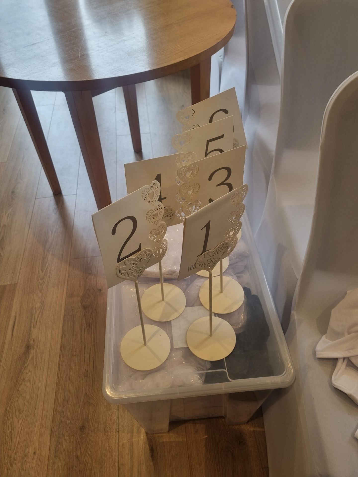 A quantity of Metal Heart Table Number Holders off white / cream