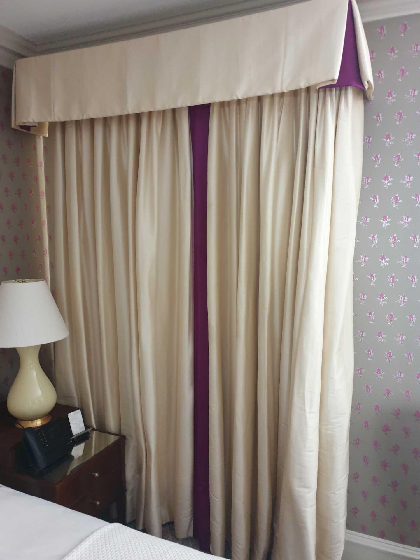 A Pair Of Cream Silk Drapes With Pelmet With Purple Trim Detail On Curtains And Purple Detail In