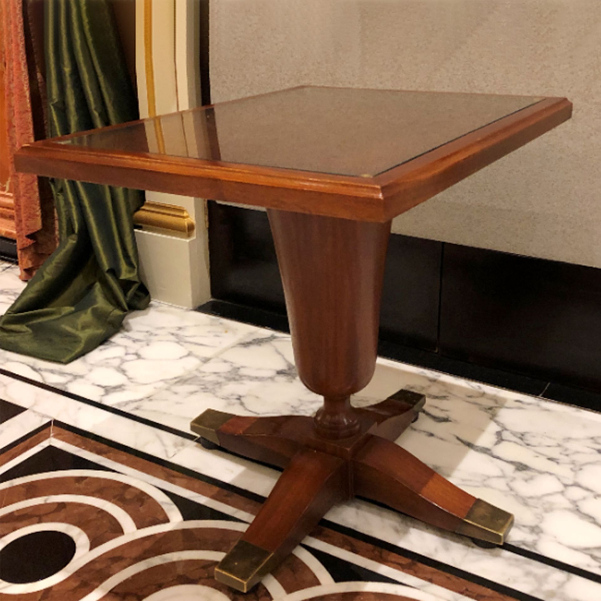 A mahogany pedestal dining table square top mounted on a heavy large turned baluster stem