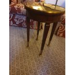 Circular Side Table With Antiqued Plate Top And Brass Trim Mounted On Tapering Legs With Brass