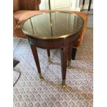 Circular Side Table With Antiqued Plate Top And Brass Trim Mounted On Tapering Legs With Brass