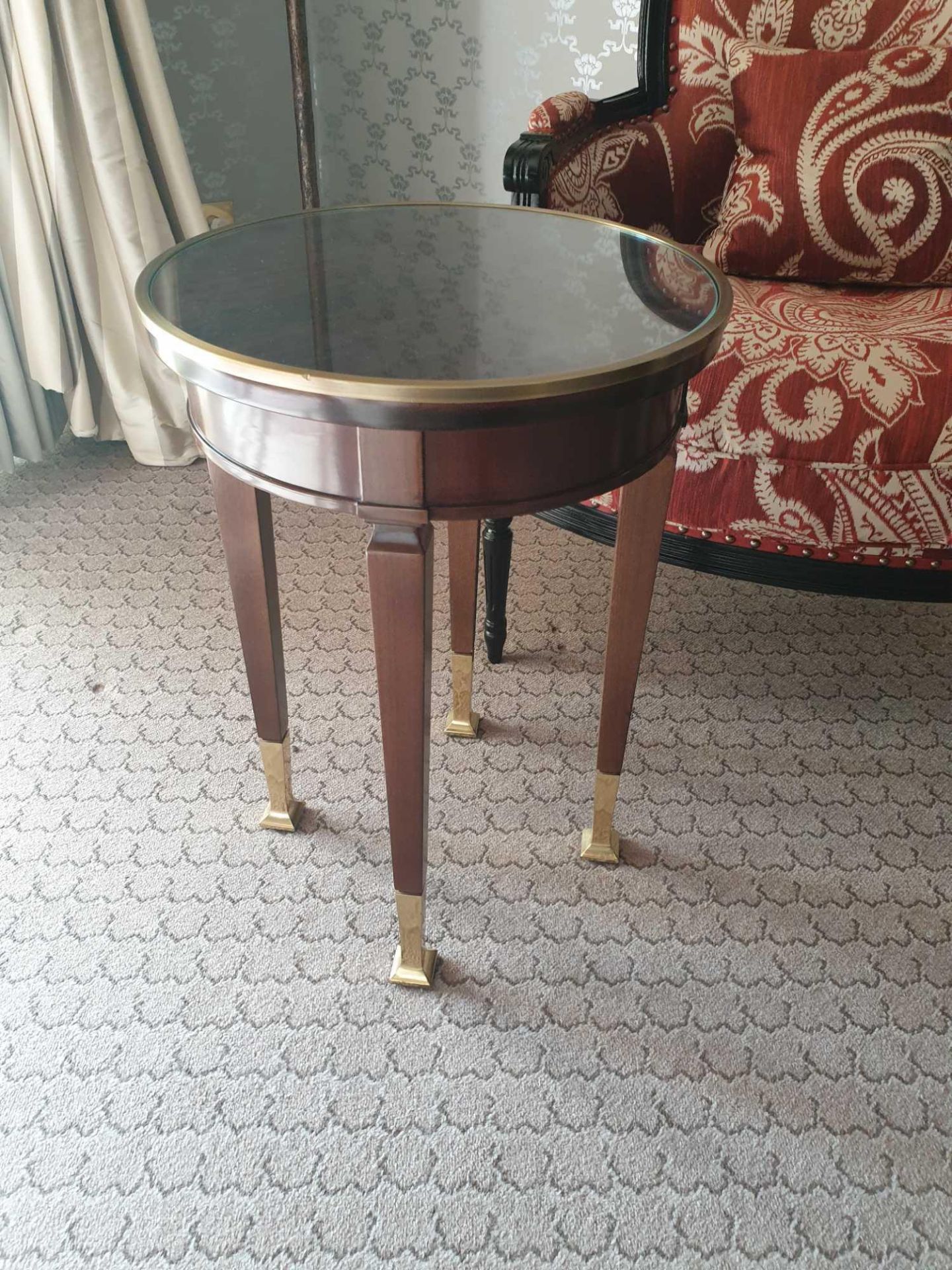 Circular Side Table With Antiqued Plate Top And Brass Trim Mounted On Tapering Legs With Brass