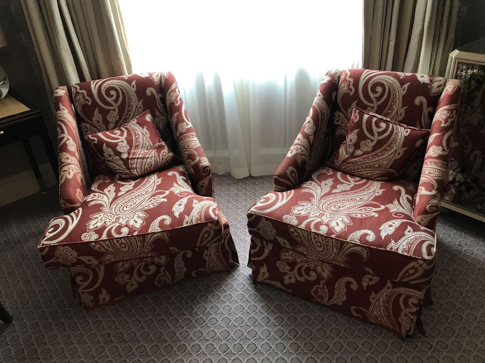 A Pair Of Bergere Chairs Black Wood Frame Upholstered In A Rust Red And Cream Damask Pattern With