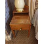 A Pair Of Two Tier Bedside Nightstands With Storage Compartments Mounted On Tapered Legs With