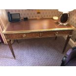 A Two Drawer Leather Tooled Inlay Writing Table With Brass Surround And Ormolu Decoration To Apron