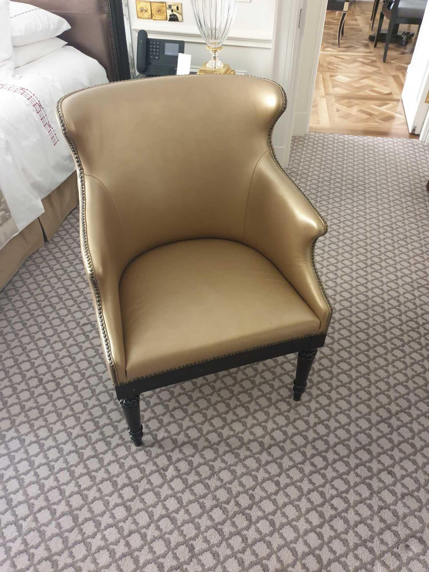 A Modern Wing Back Accent Chair Upholstered In Gold Leather With Pin Stud Detail On Dark Solid - Bild 2 aus 2