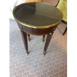 Circular Side Table With Glass Plate Top And Brass Trim Mounted On Tapering Legs With Brass Foot