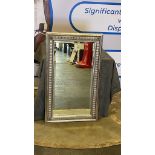 A decorative framed wall mirror the frame in a washed antique silver wood 60 x 100cm