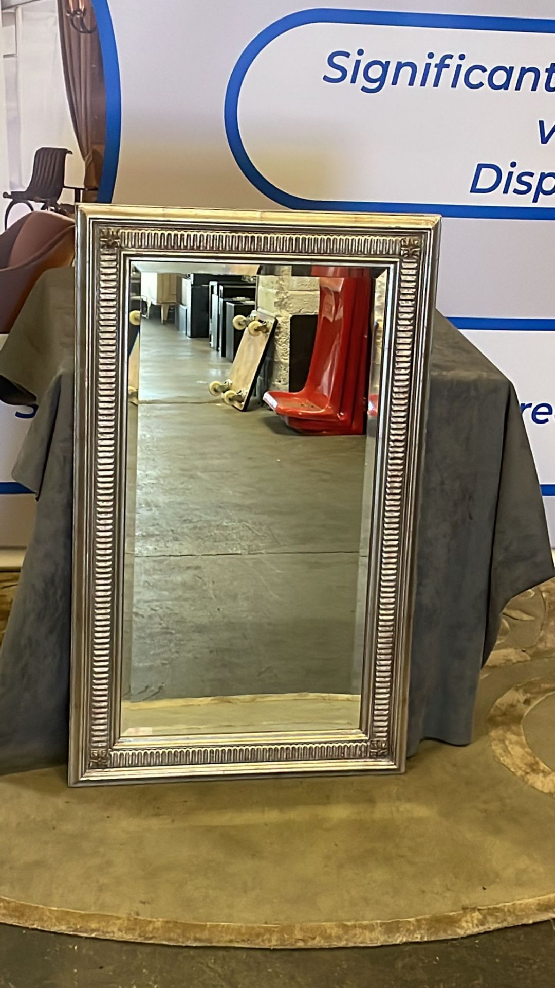 A decorative framed wall mirror the frame in a washed antique silver wood 60 x 100cm