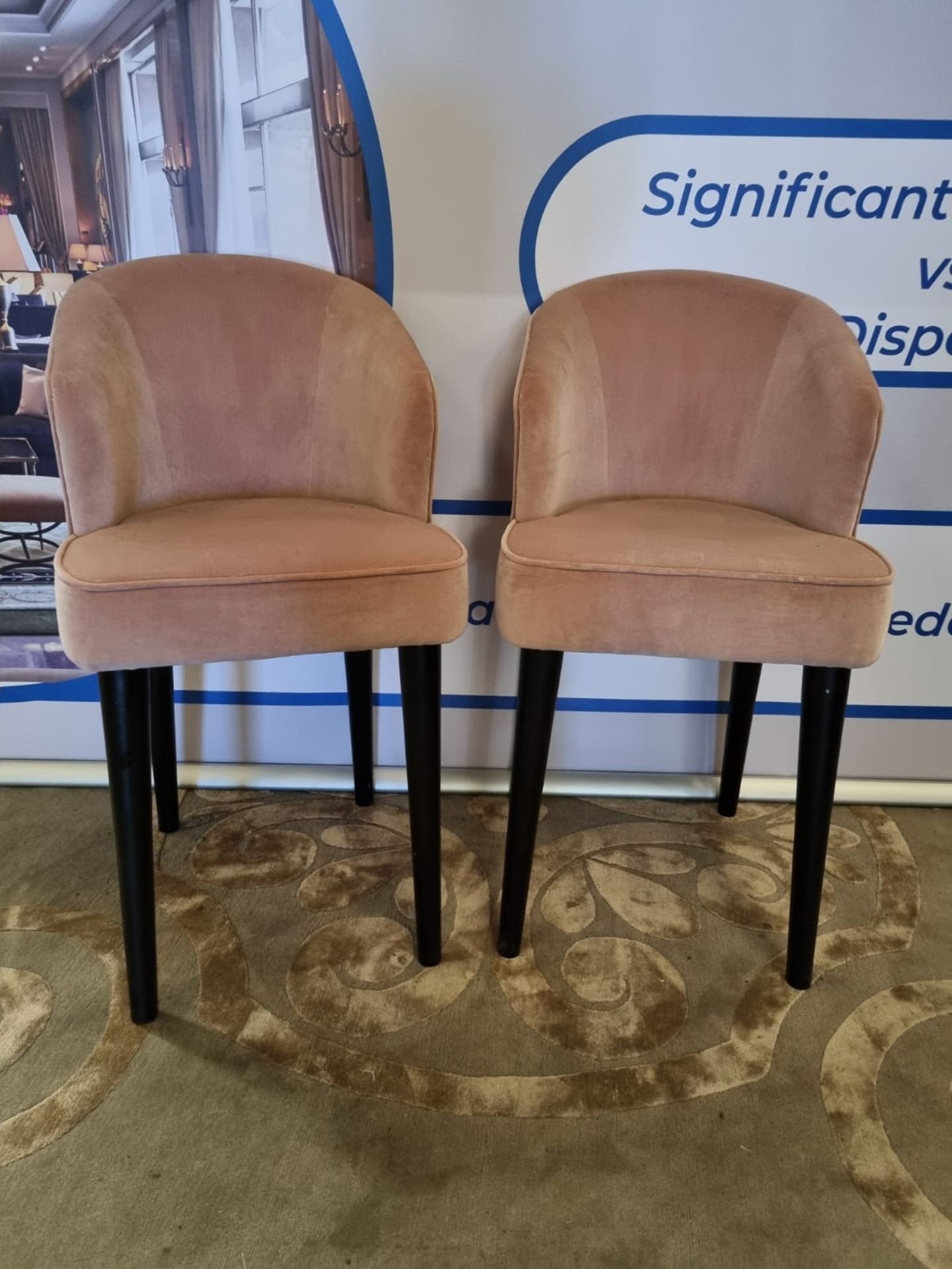 A pair of Rich Pink Velvet Curved Design bar stools on black frame legs 52 x 45 x 100cm