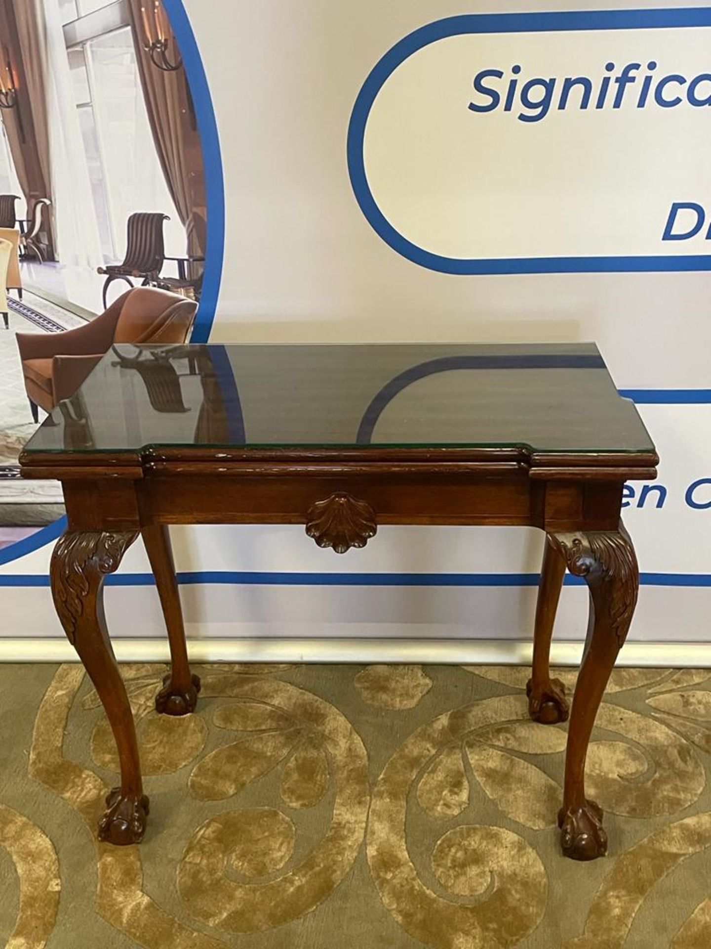 A George II style mahogany tea table With central drawer on carved acanthus knees and ball & claw