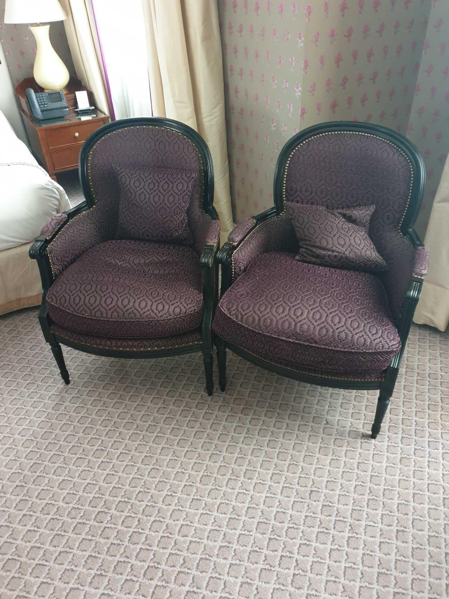 A pair of Ã‚ Bergere Chair Black Wood Frame Upholstered In A Dark Mauve Pattern With Stud Pin Detail