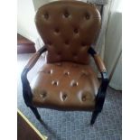 A leather library desk chair upholstered in fine buttoned leather with stud pin detail to frame