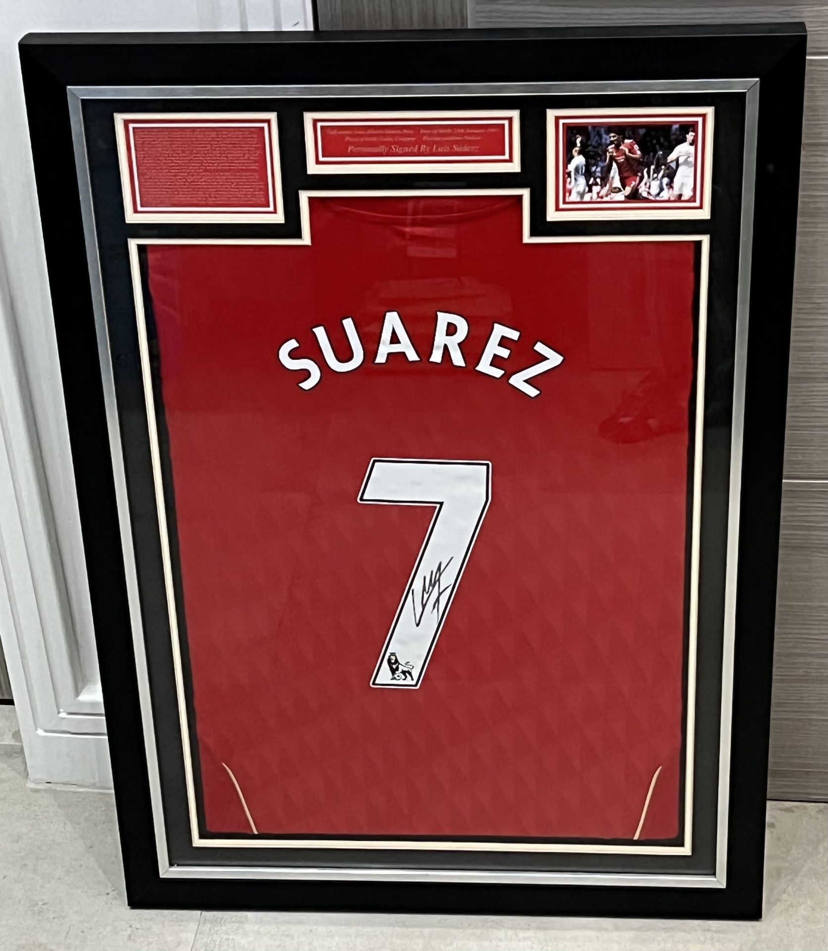Authentic Luis SuÃ¡rez hand signed Liverypool 7 shirt. The shirt is displayed in a professional