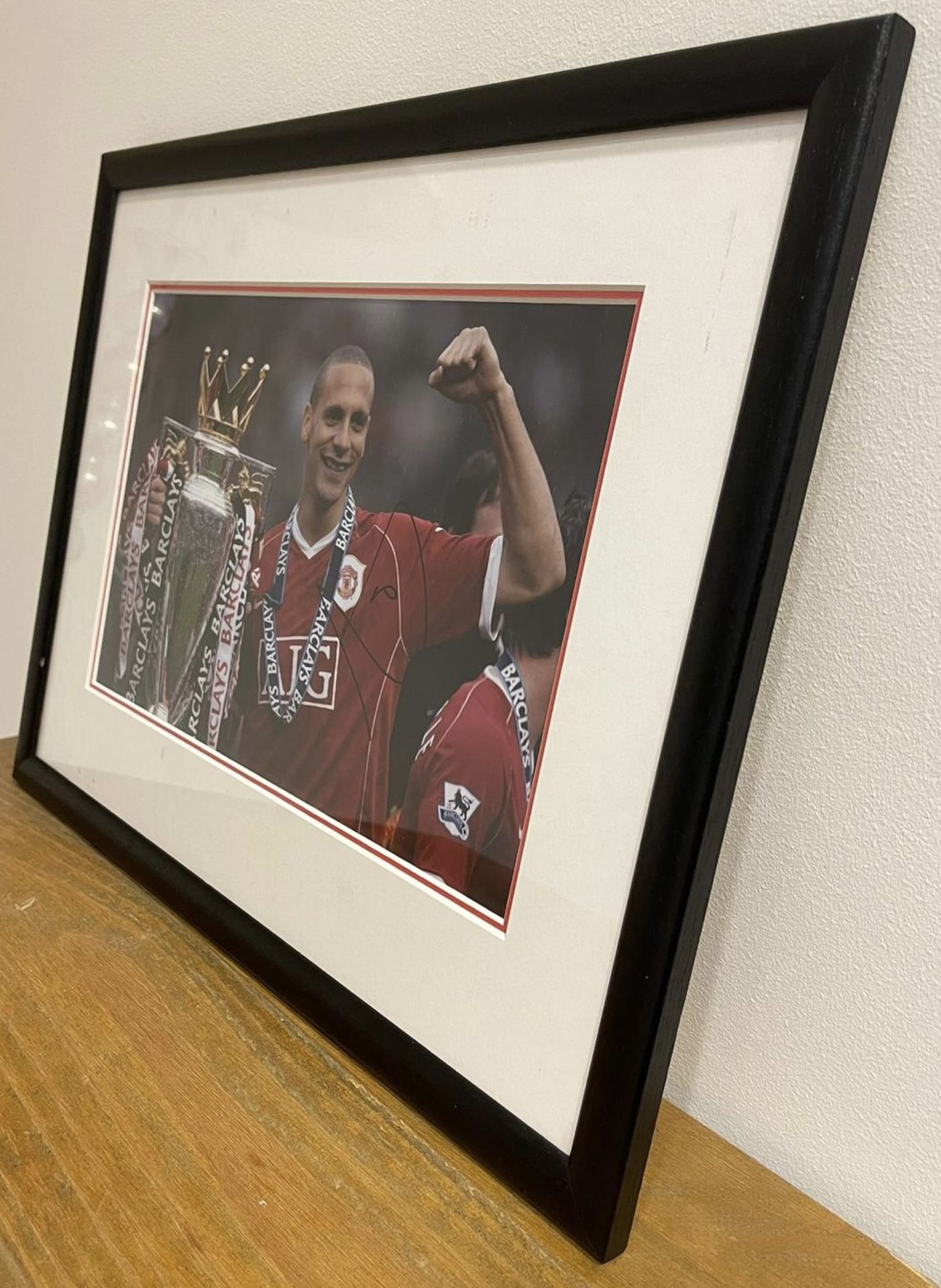 Hand signed Rio Ferdinand photograph featuring him with title winning trophy for Manchester United - Image 3 of 6