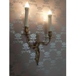 A pair of twin arm antique candle style brass wall sconces lights