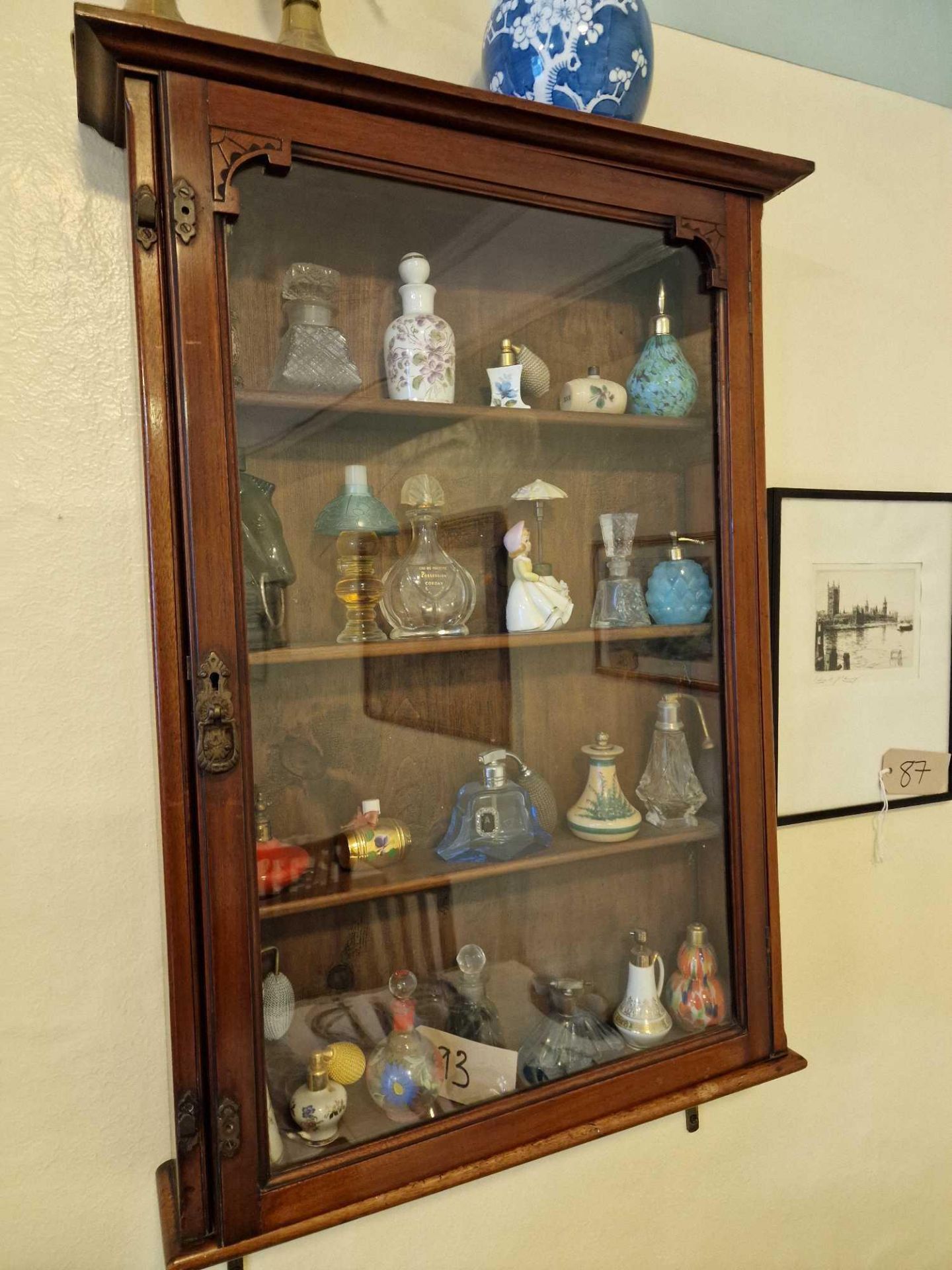A Glazed Wooden Wall Mounted Display Cabinet To Include The Contents Of 24 X Various Vintage Perfume