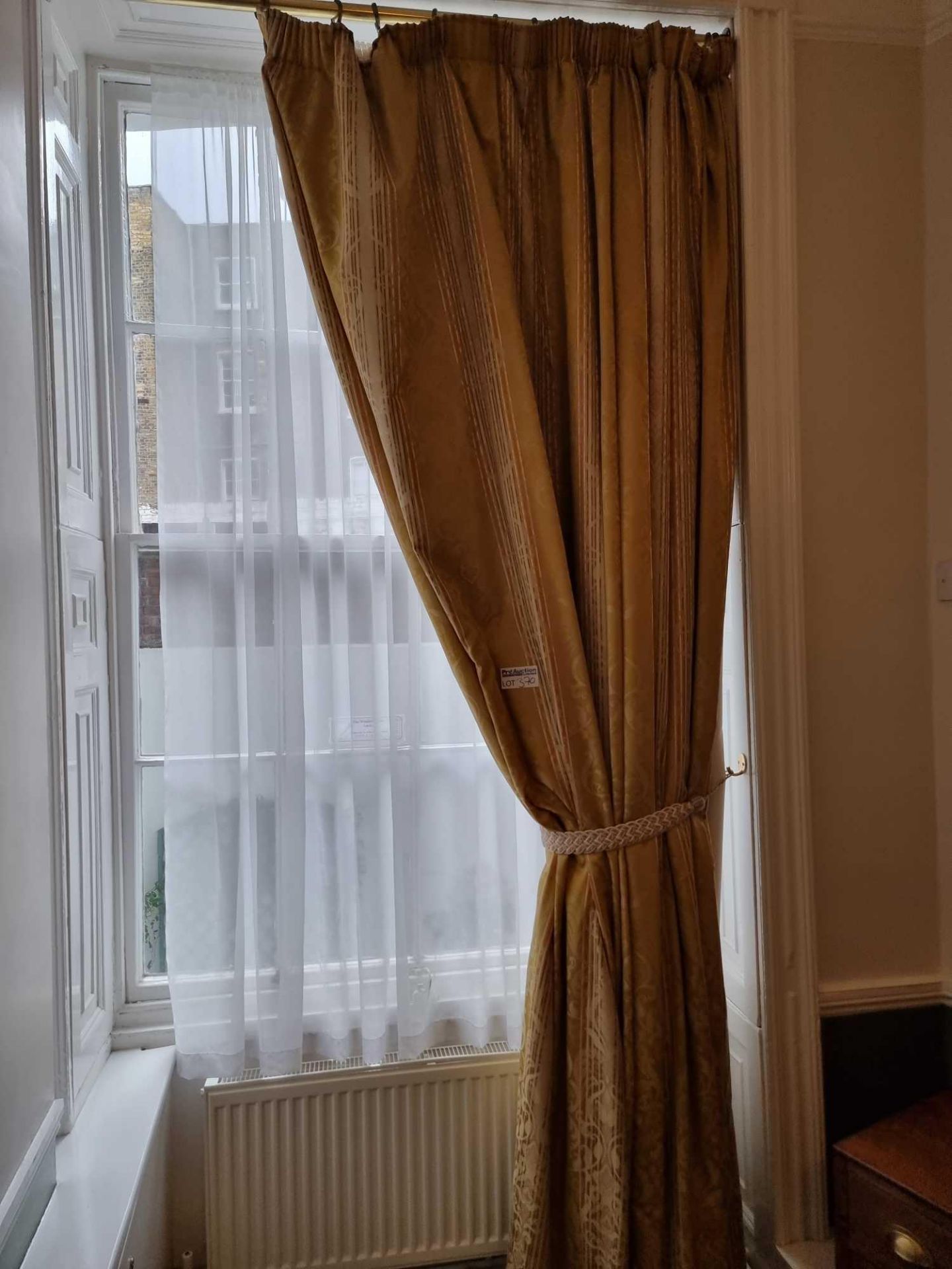 A Single Panel Drape Curtain In Gold Stripped Pattern On A Polished Brass Pole Spans 140 X 290cm (