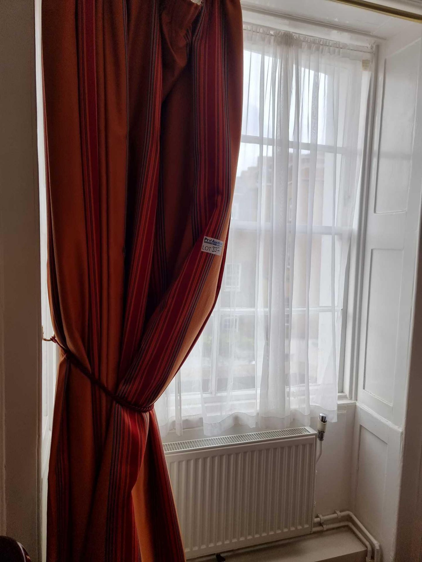A Single Drape Curtain Ring Top In Red Gold And Rust Stripe On Brass Curtain Poles Span 135 X