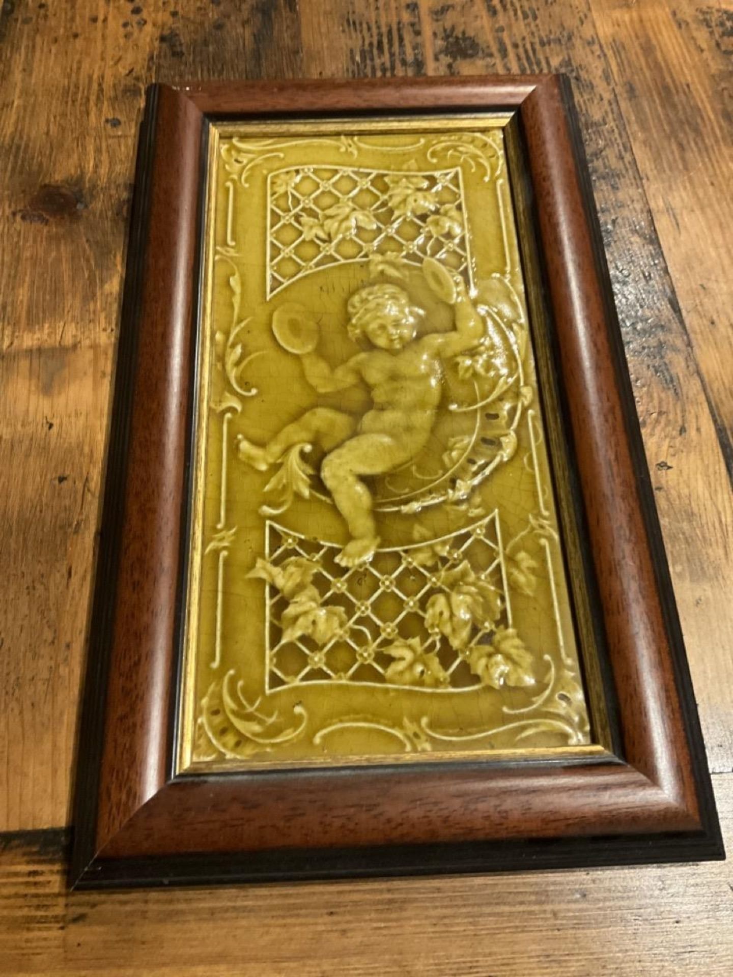 A Pair Of Framed Painted And Glazed  Tiles Depicting Putti / Cherubs  Playing Musical Instruments In - Image 3 of 6