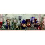 LARGE SHELF OF COLOURED GLASSWARE WITH GOBLETS, VASES, CANDLE HOLDERS ETC