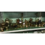 SHELF OF BRASS WARE, ORNAMENTS, CANDLESTICKS ETC