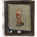 ANTIQUE WOOL WORK PANEL OF A CHILD CARRYING A DOG IN A CARVED WOOD FRAME