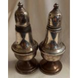 A PAIR OF STERLING SILVER PEPPER CASTERS, GLASS INTERIOR